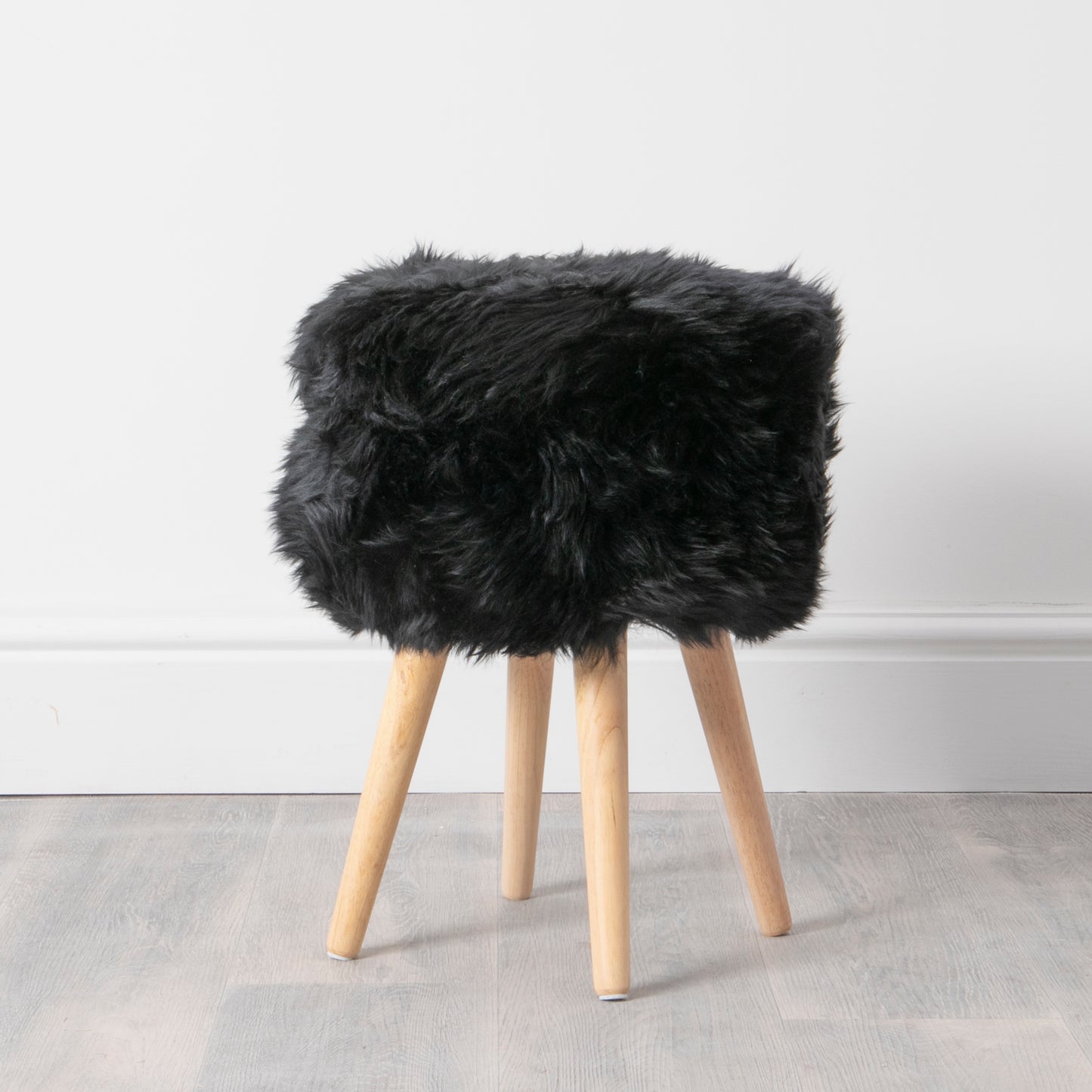 Black Sheepskin Stool with Light Wooden Legs